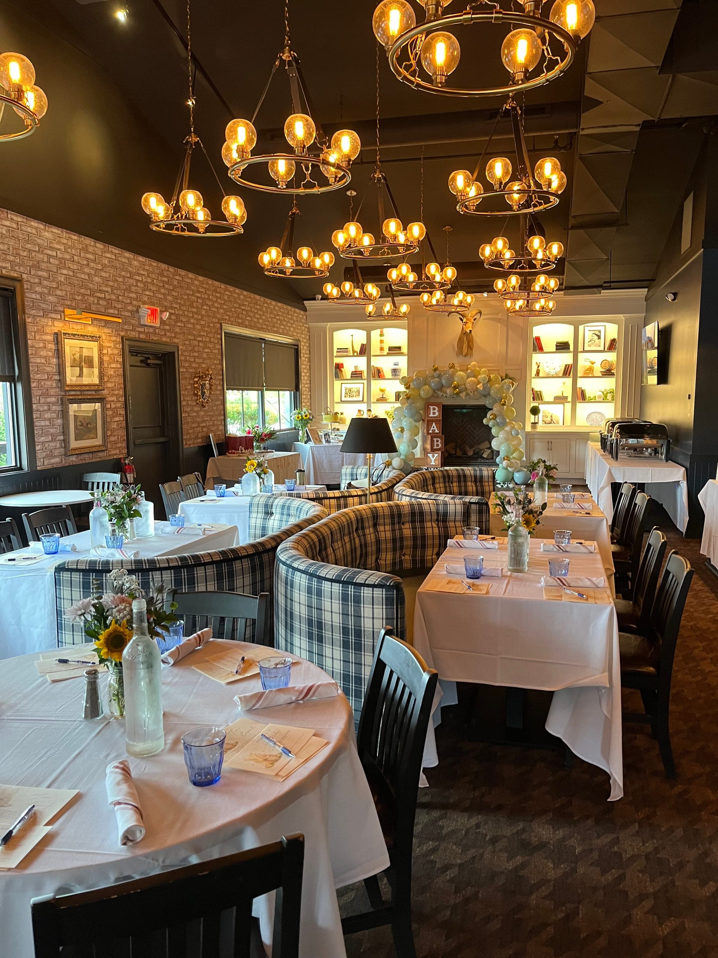 The Library set with white linens, sunflowers and a balloon arch for a baby shower brunch at Crown Tavern in Glen Mills, PA
