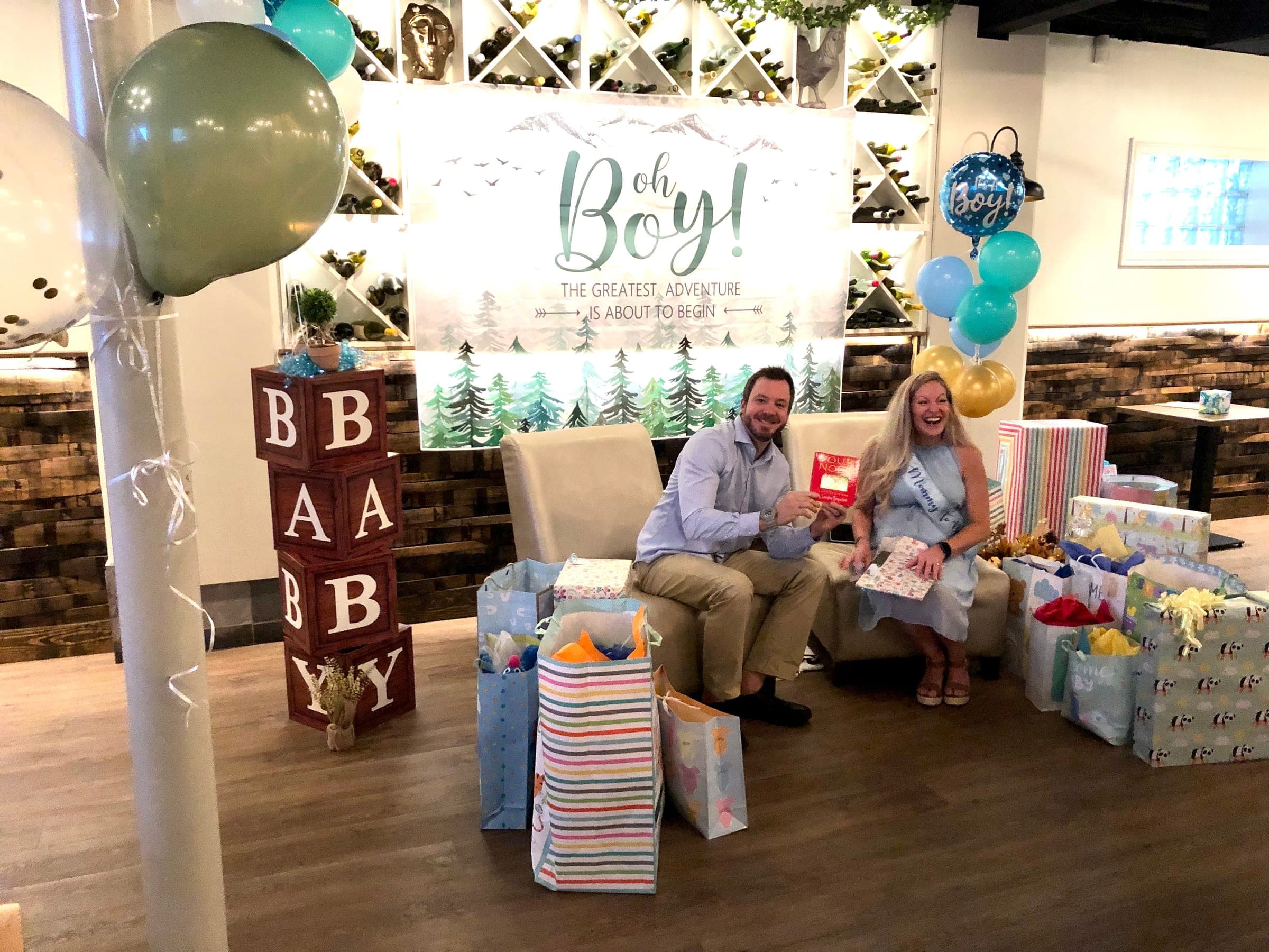 Parents-to-be opening gifts at a baby shower in the Wine Cellar at Crown Tavern in Glen Mills, PA