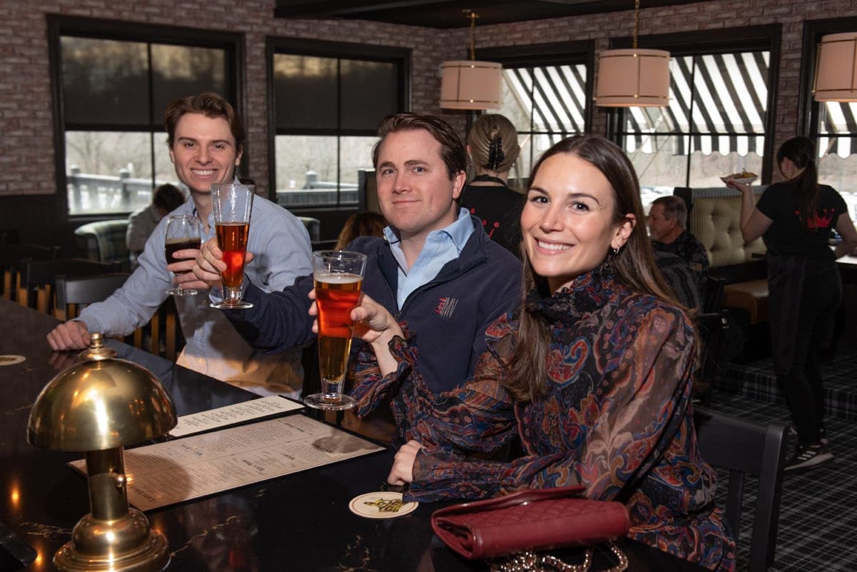 Guests toasting drinks at the bar at The Crown Tavern, private events venue in Glen Mills, PA