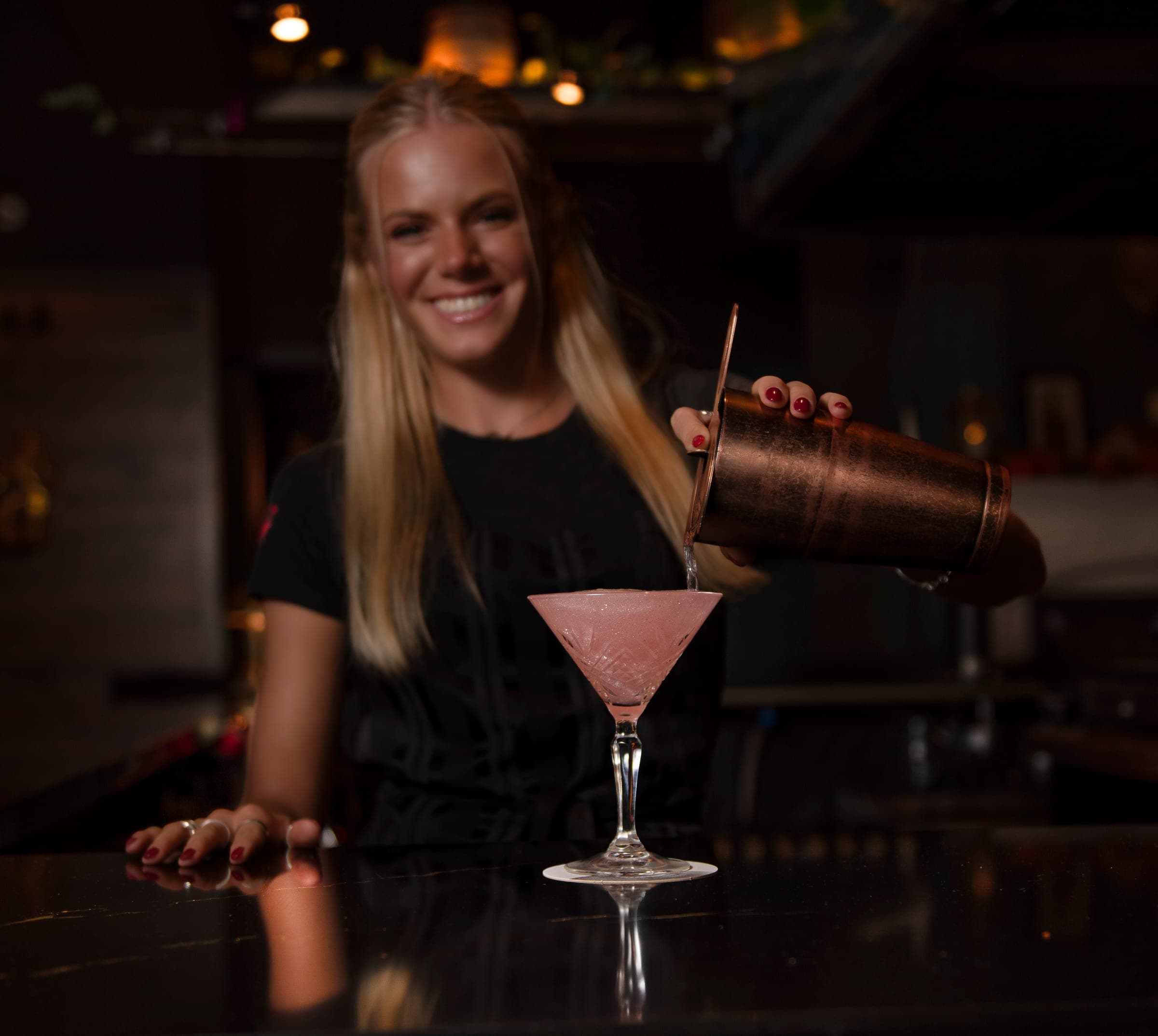 Bartender pouring a cocktail at The Crown Tavern bar in Glen Mills, PA