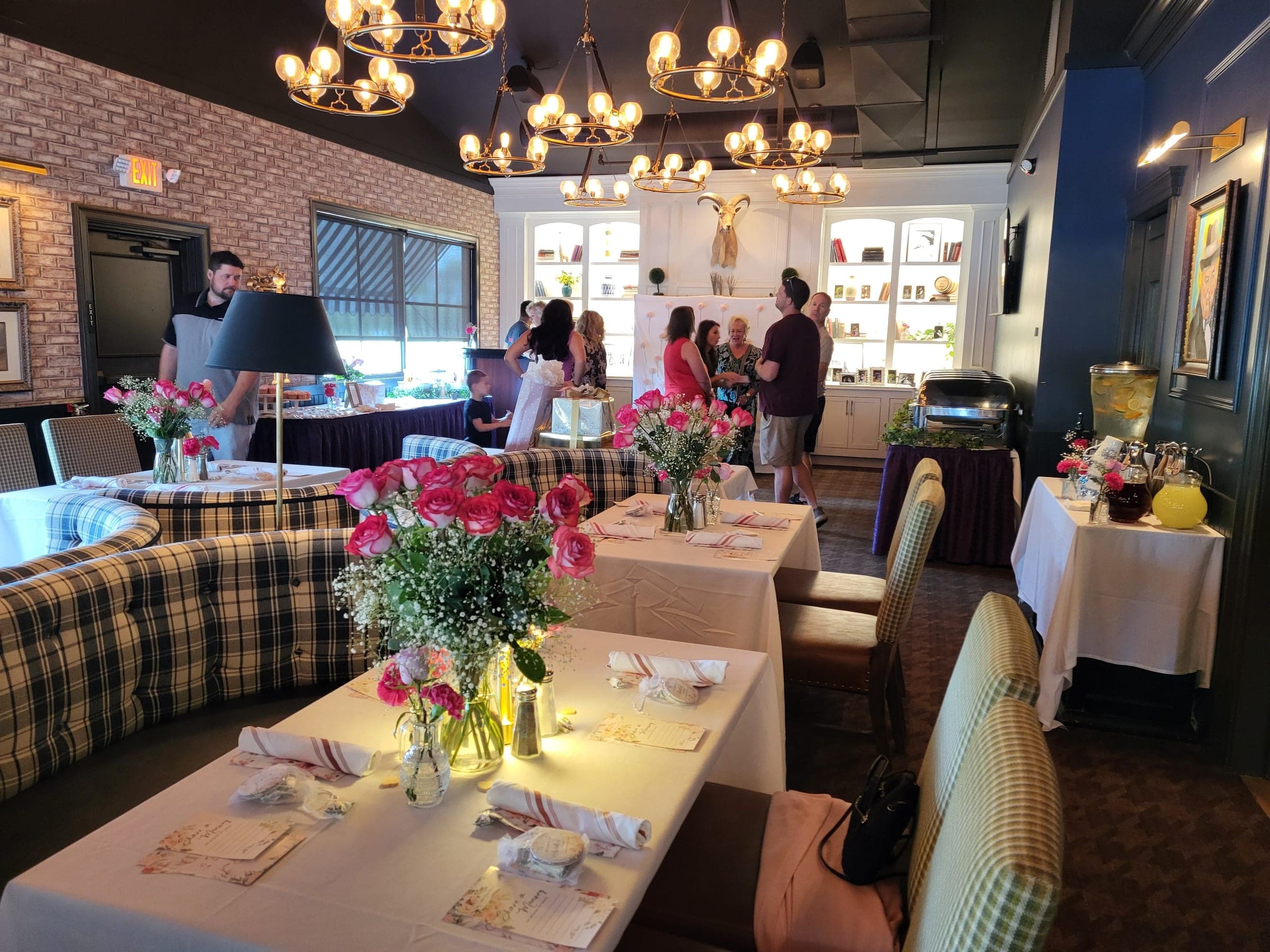 The Library set with pink roses for a bridal shower brunch, guests arriving, at Crown Tavern in Glen Mills, PA