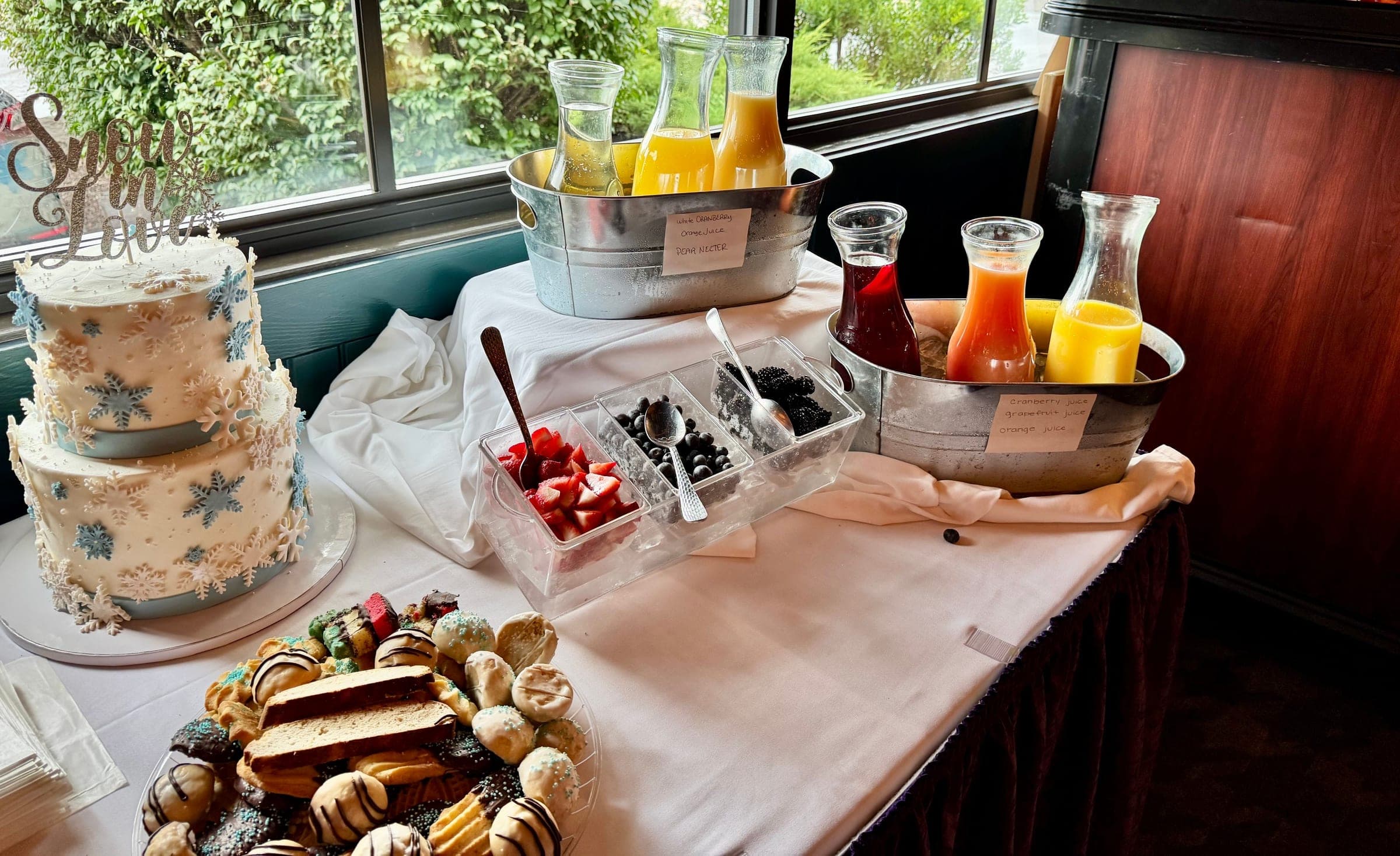 A bridal shower cake beside juice carafes for the mimosa bar and a tray of desserts at Crown Tavern in Glen Mills, PA