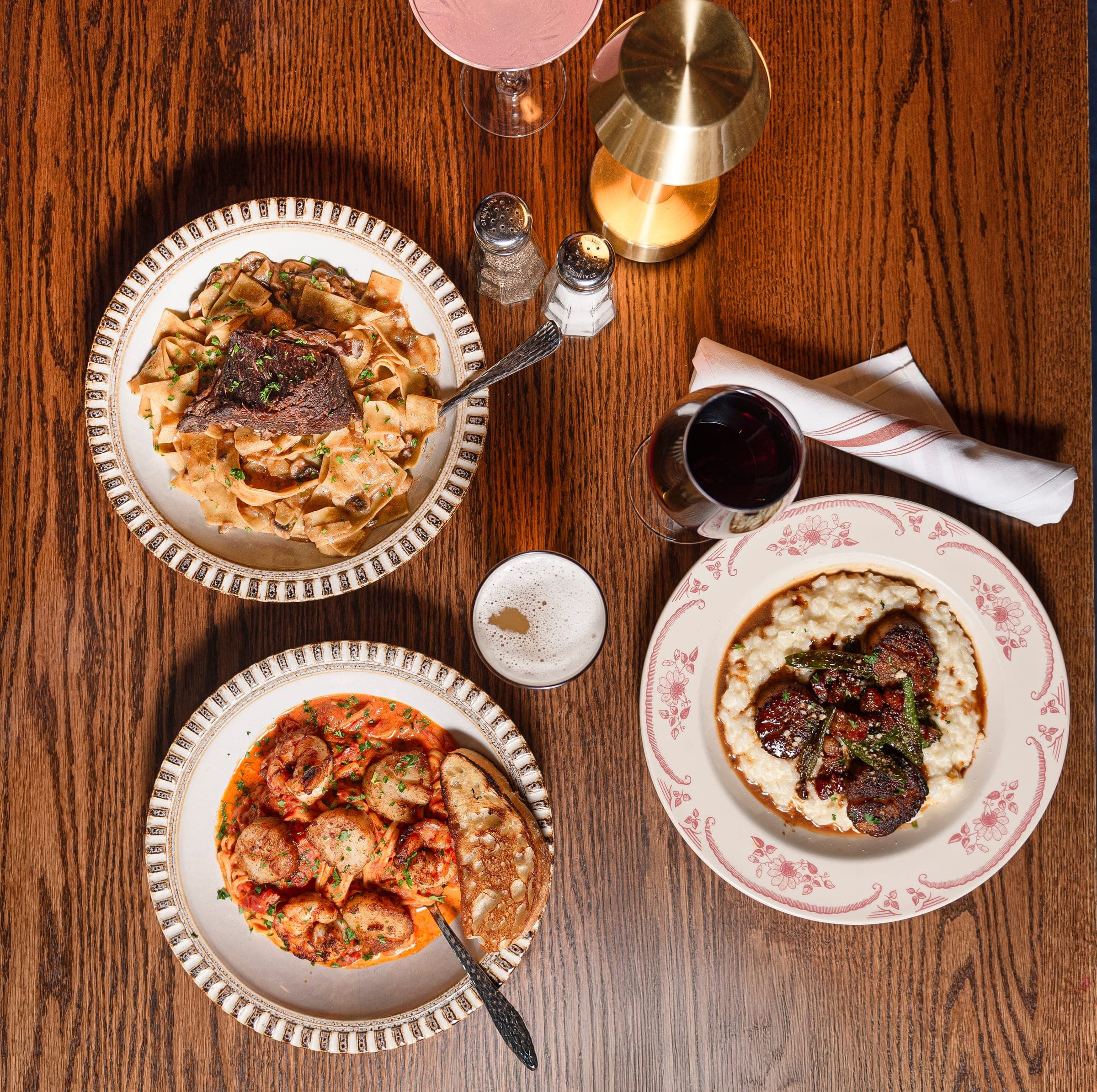 Overhead spread of dishes, wine, and cocktails at The Crown Tavern in Glen Mills, PA