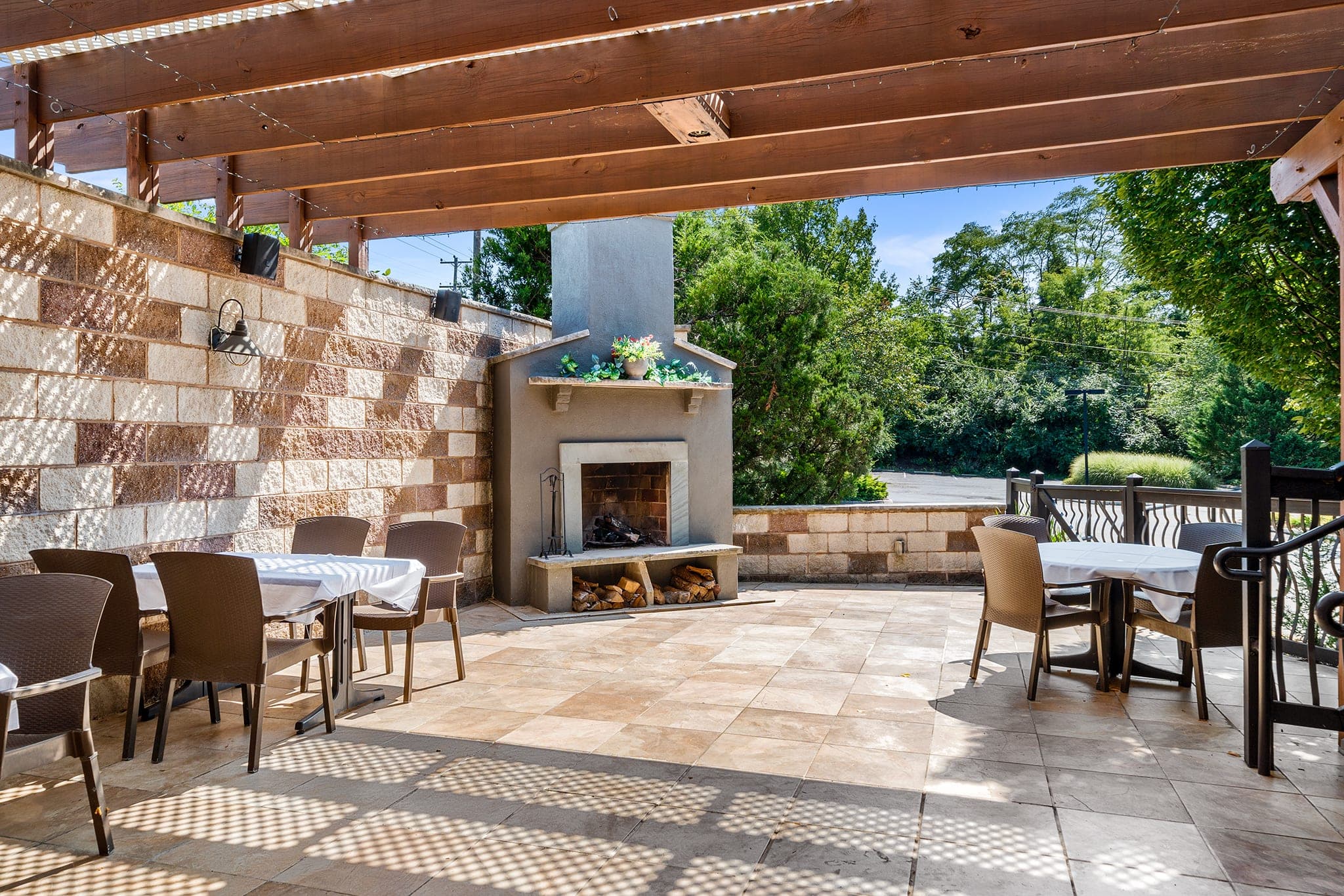 The covered garden patio with an outdoor fireplace set for a company cocktail party at Crown Tavern in Glen Mills, PA