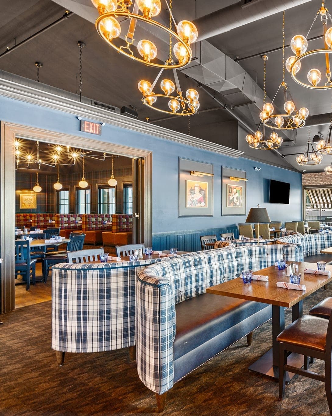 The Library private dining room with tartan banquettes and brass chandeliers, set for a rehearsal dinner at Crown Tavern in Glen Mills, PA