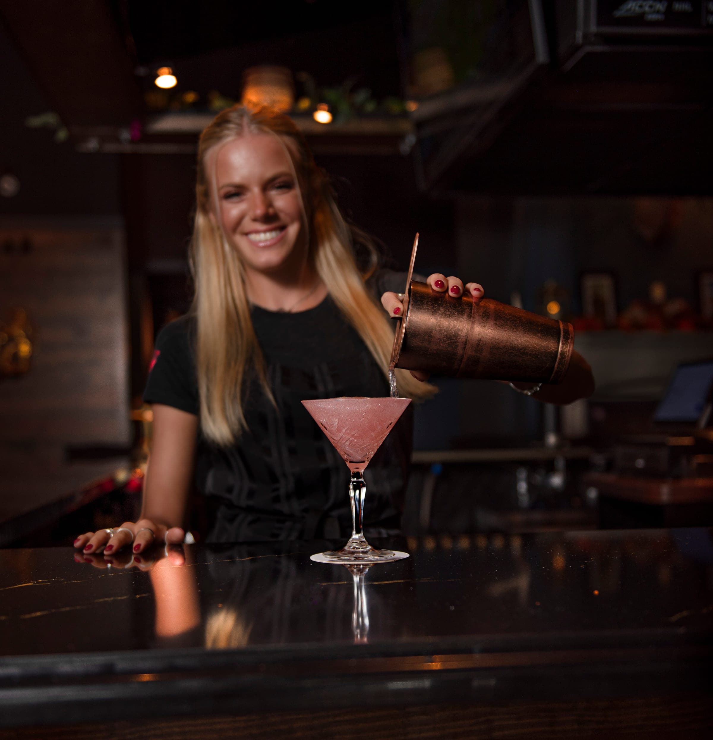 A bartender pouring a handcrafted cocktail at The Crown Tavern in Glen Mills, PA
