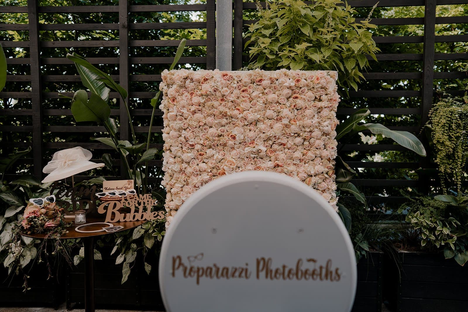 Proparazzi Photobooths photo booth facing a blush rose flower wall backdrop set up for a bridal shower